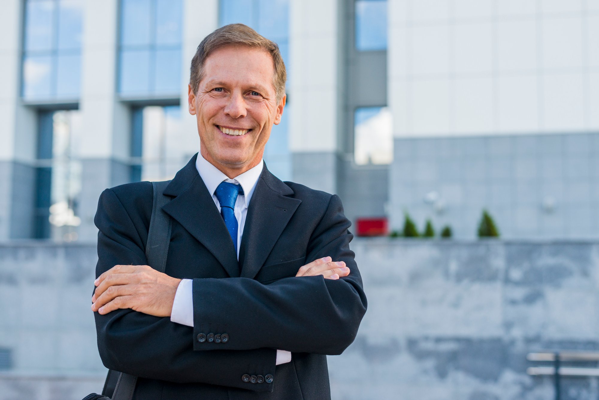 portrait-happy-mature-businessman-with-folded-arms